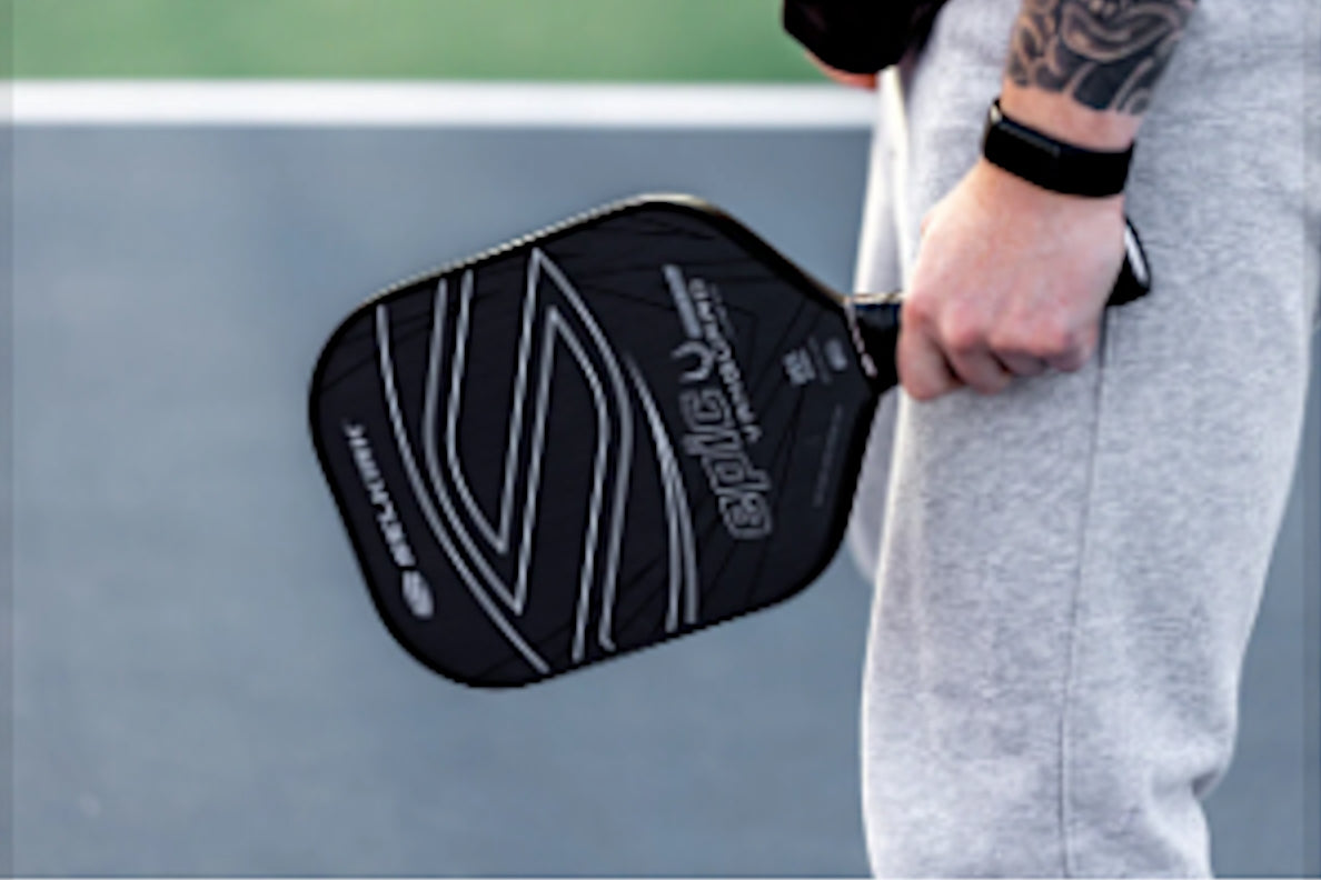 A person holding the Selkirk VANGUARD Control paddle, showcasing its design and grip.
