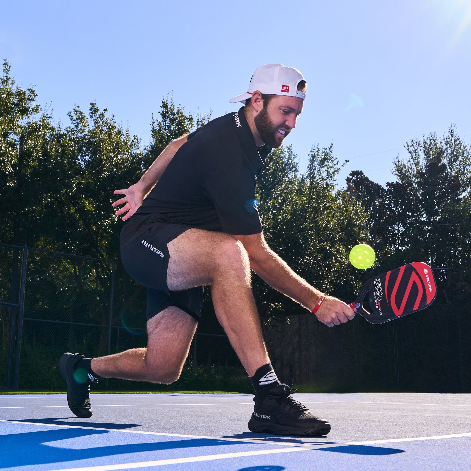 Jack Sock hits a backhand with the Selkirk Vanguard Power Air paddle. 