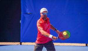 Morgan Evans playing pickleball, preparing to hit a ball with a paddle.