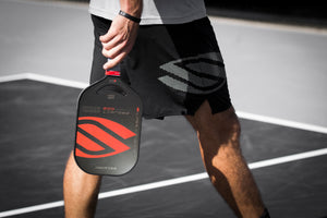 A pickleball player carrying the Selkirk LABS Project 002 pickleball paddle.