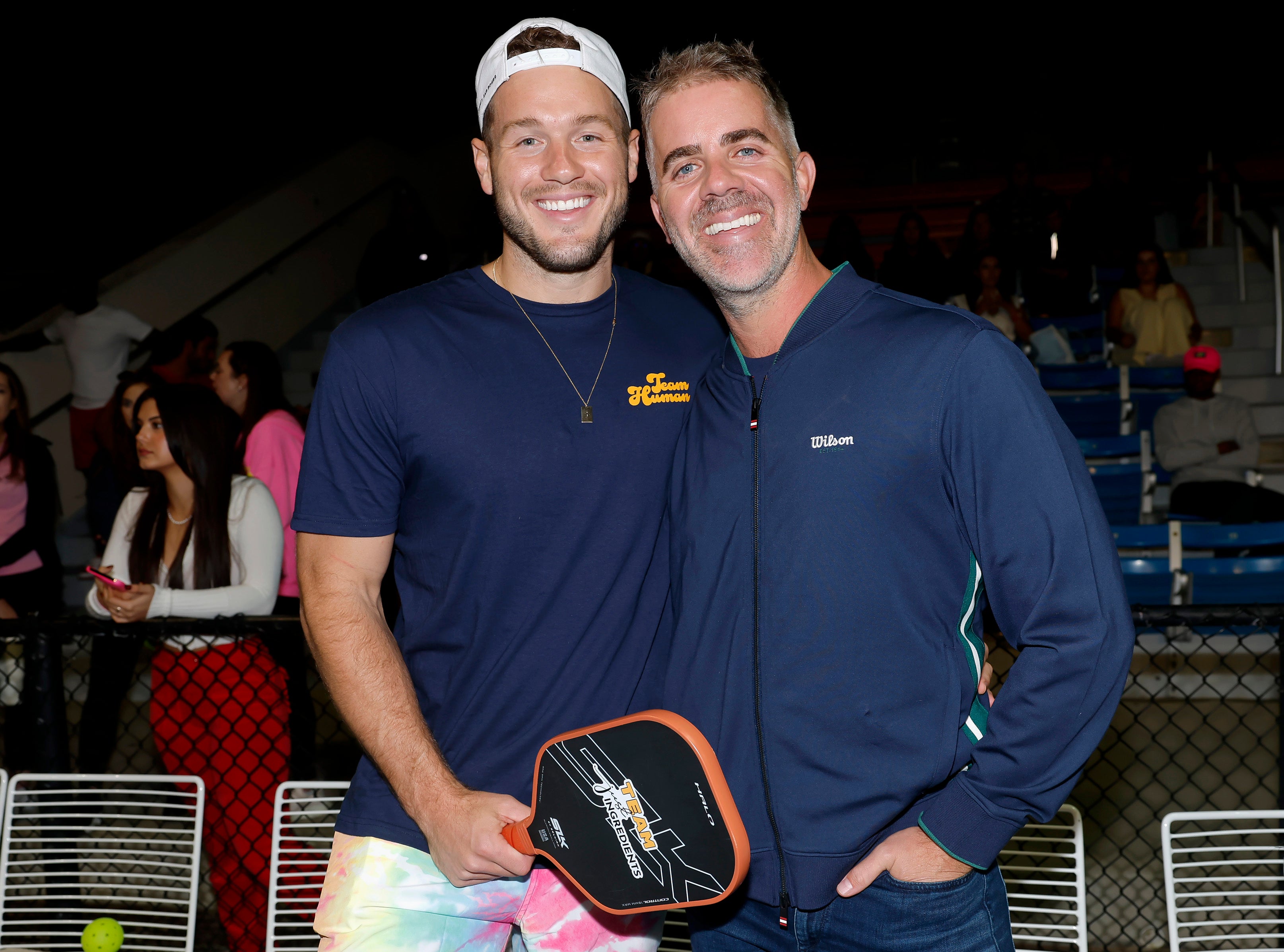 Colton Underwood and Cameron Gilliam smiling together at the Pickle! For Purpose Celebrity Pickleball Tournament