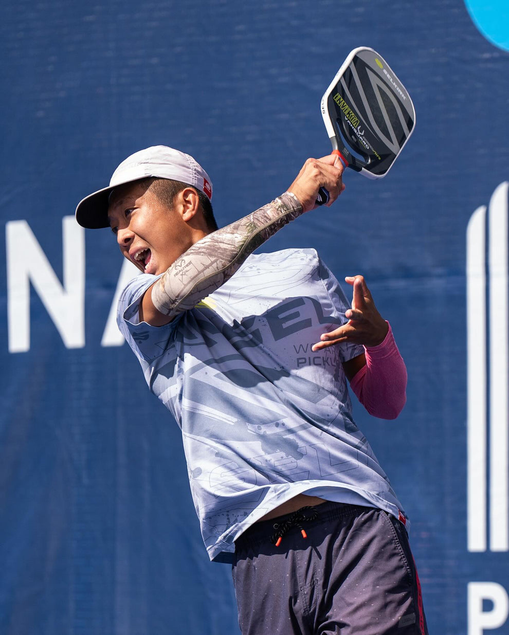 Quang Duong playing pickleball, swinging a paddle