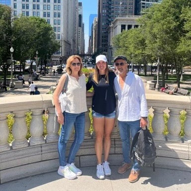 Pickleball pro Judit Castillo with her mother and father in a city park, expressing gratitude for her mother's support.
