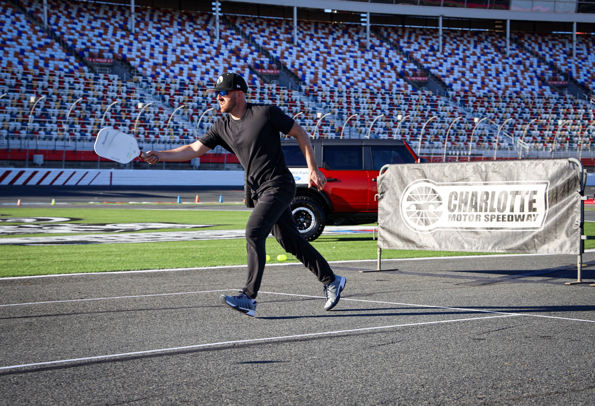 NASCAR driver Austin Dillon playing pickleball at Charlotte Motor Speedway
