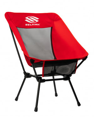Selkirk Sport Low-Profile Mesh Pickleball Court Chair in red and gray, showcasing its portable design.