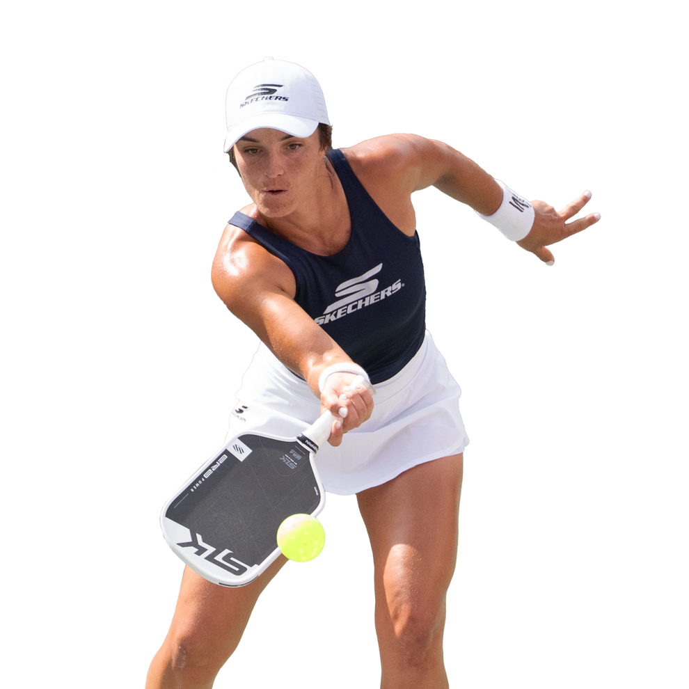 Pickleball player lunging to hit a neon ball, wearing SKECHERS cap and top and holding a paddle