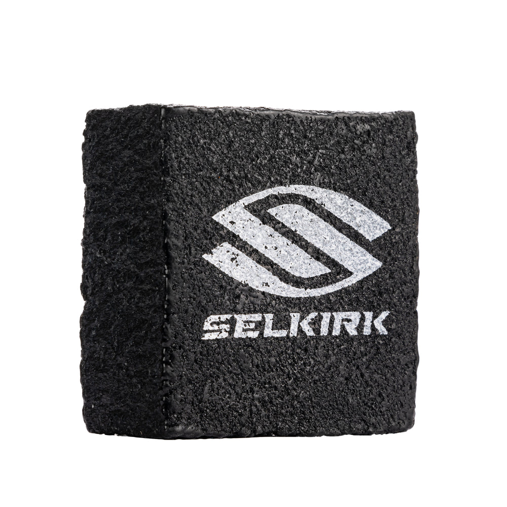 Black Selkirk cleaning block for raw carbon fiber paddles with logo