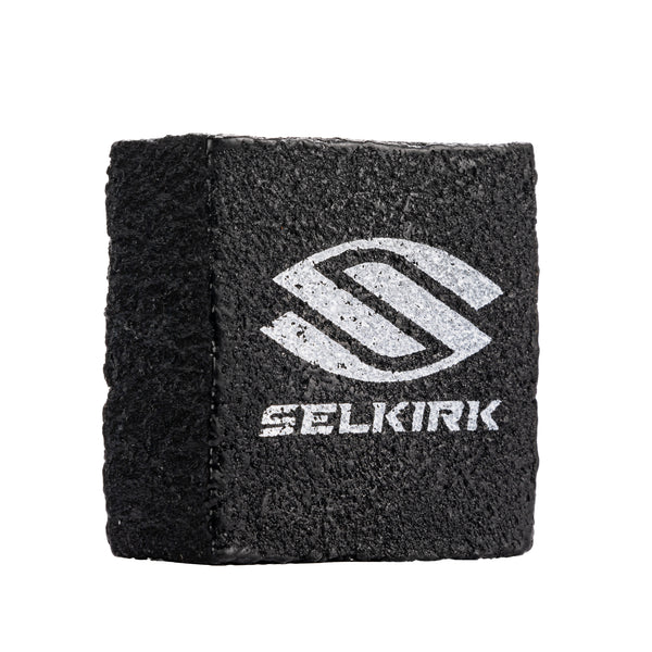 Black Selkirk cleaning block for raw carbon fiber paddles with logo