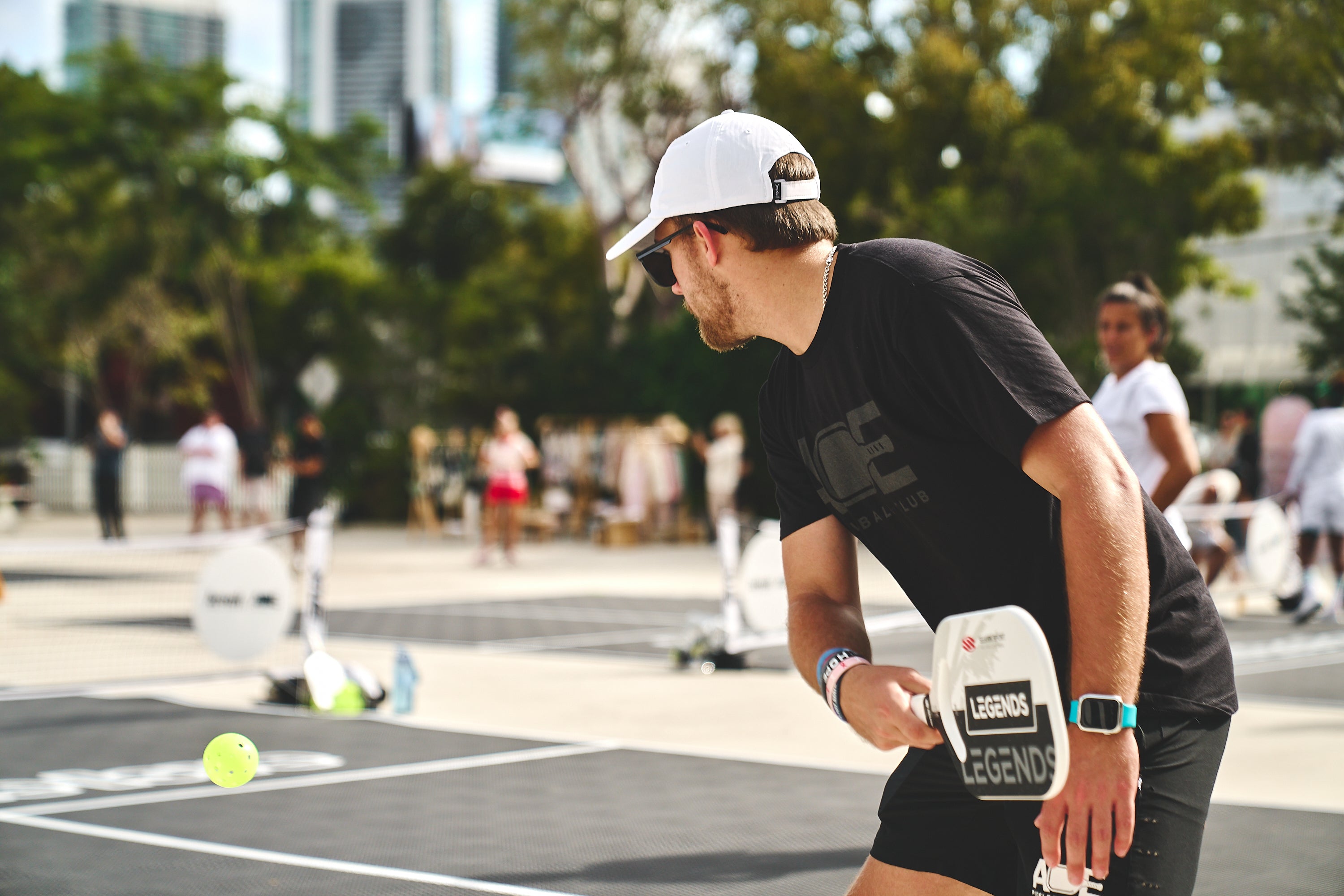 A player preparing to serve a pickleball during the PICKLEBASEL event in Miami.