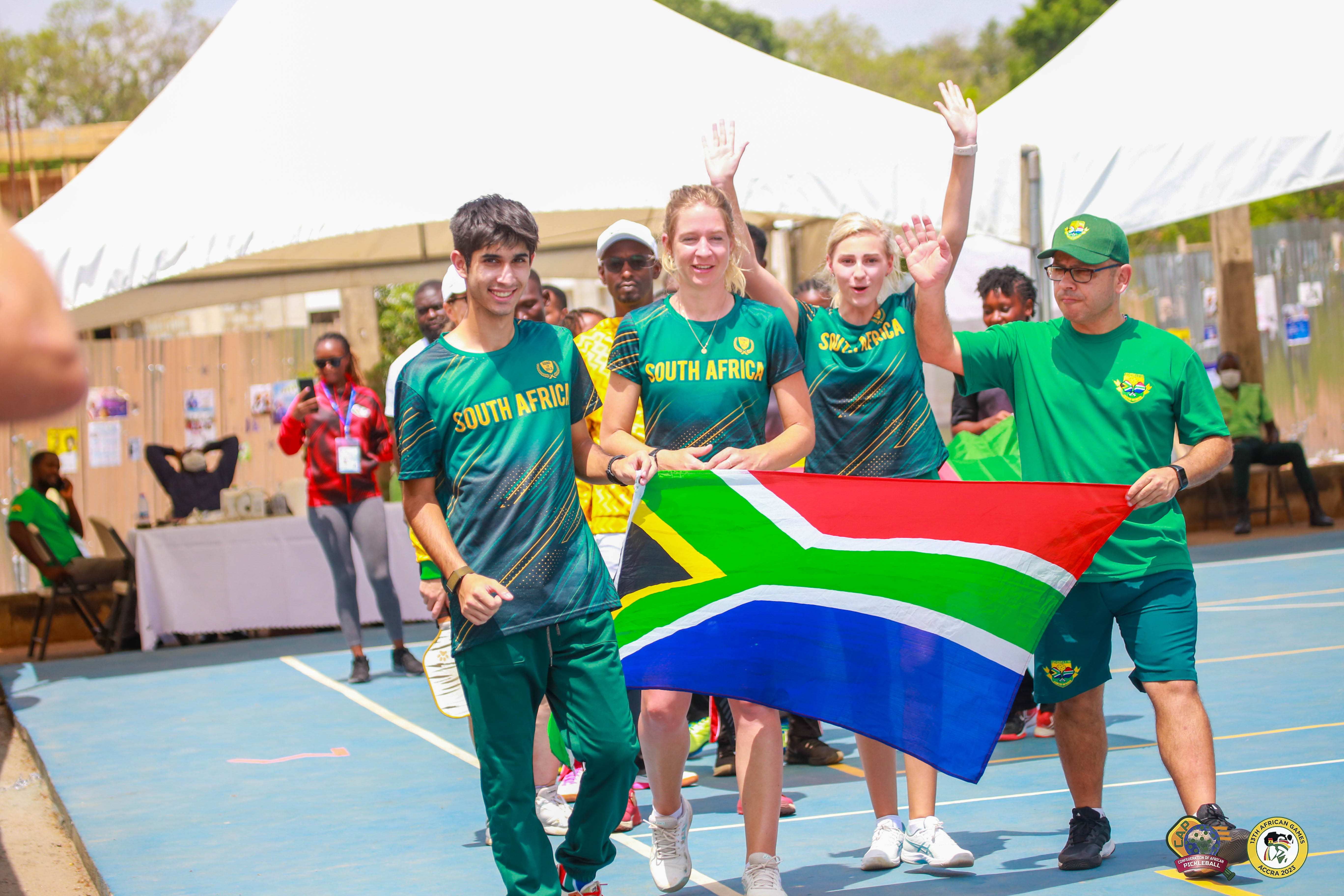 South African pickleball team celebrating with a flag at the 13th African Games