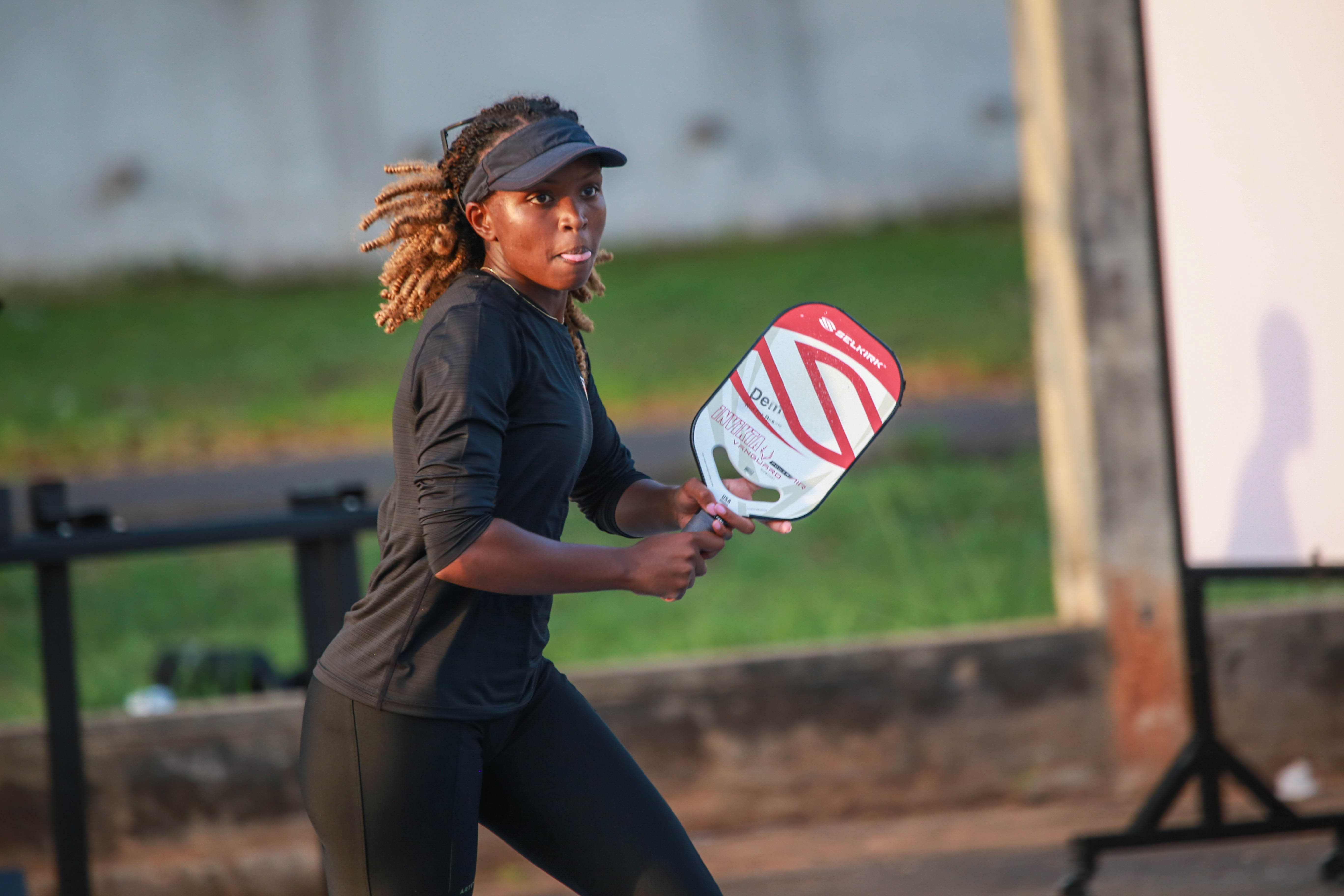 A woman playing pickleball with a Selkirk Power Air Invikta paddle.