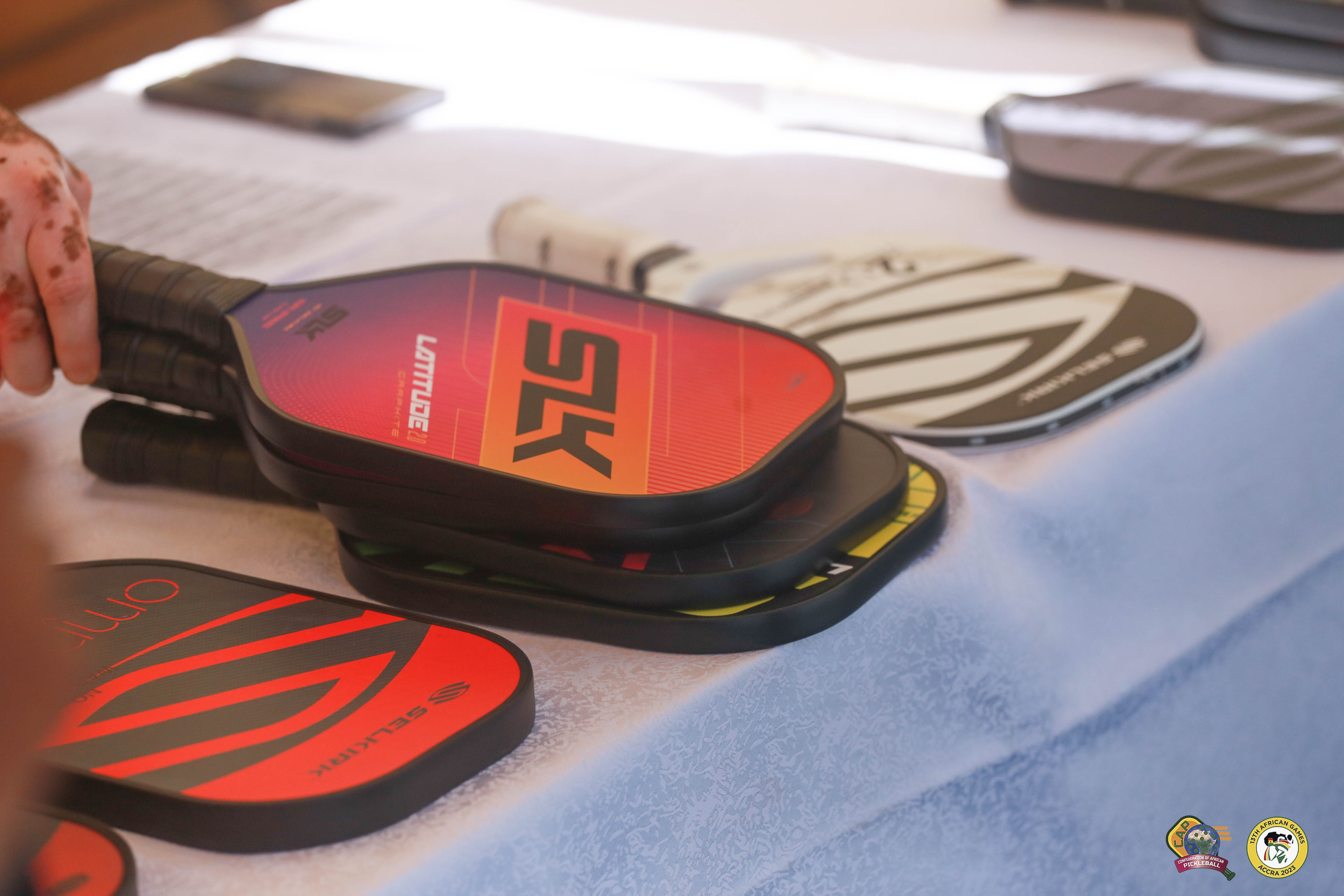Various Selkirk pickleball paddles displayed on a table