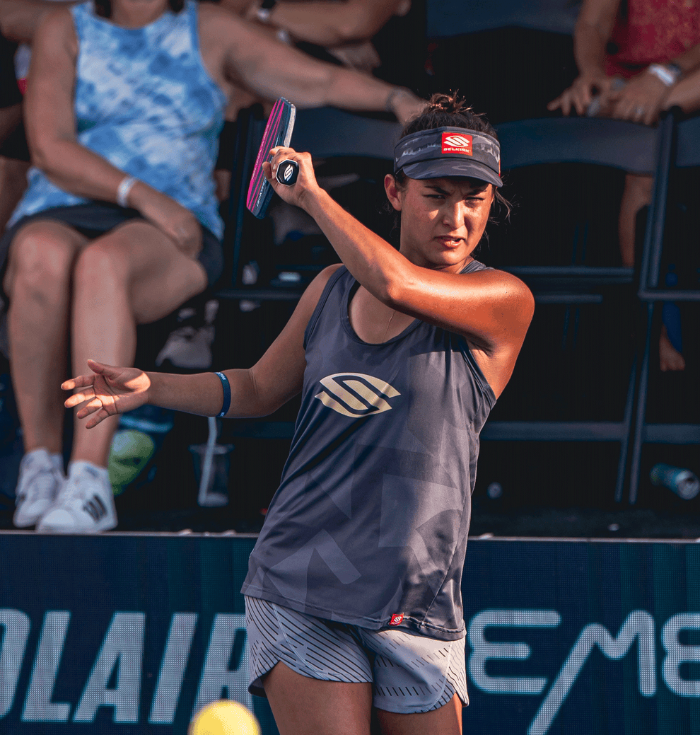 Jade Kawamoto preparing to hit a pickleball, wearing a gray tank top and headband.