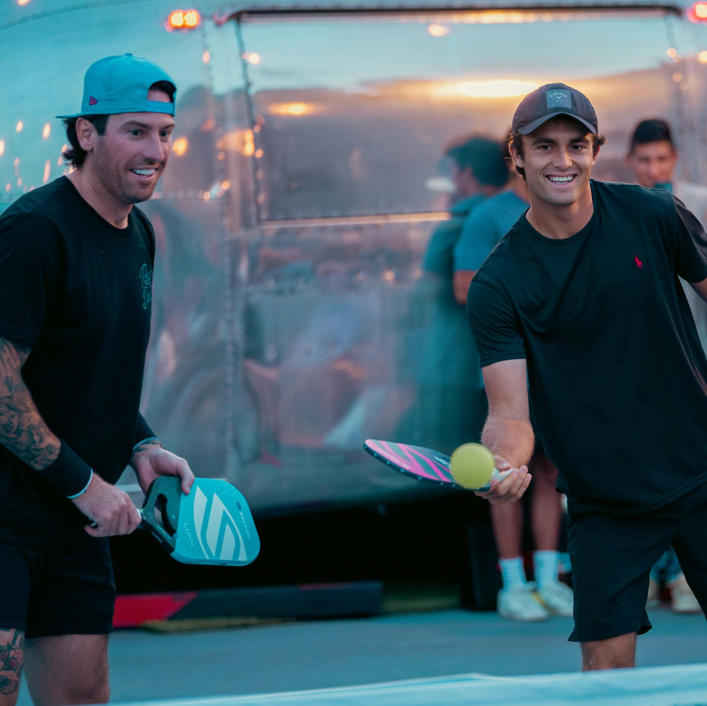 James Neal and James Ignatowich playing pickleball, smiling and holding paddles.
