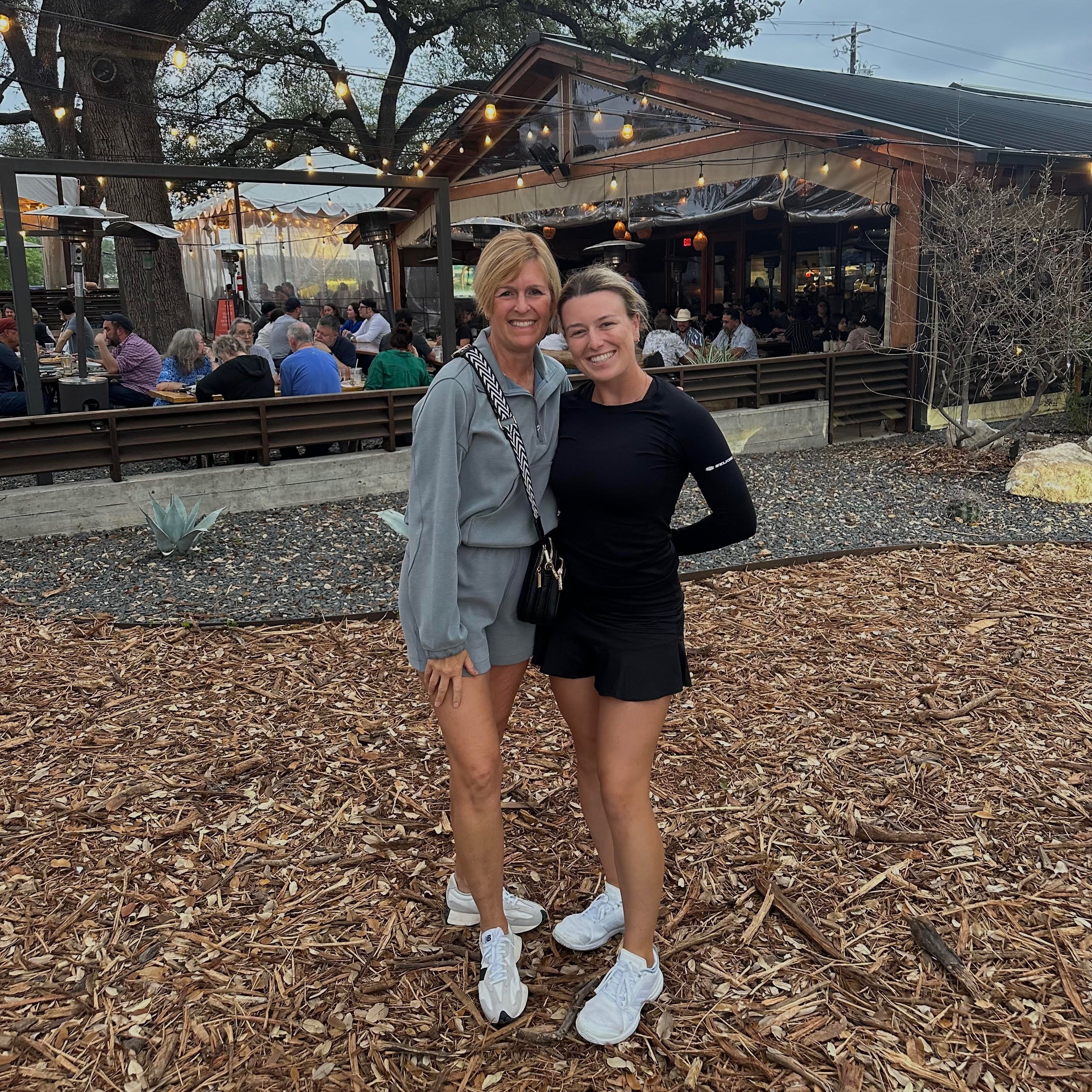 Pickleball pro Mary Brascia and her mom posing together outdoors, celebrating their bond and love for pickleball.
