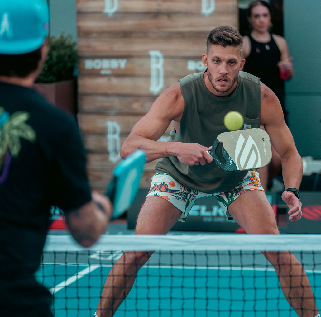 Professional pickleball player prepares to hit a ball during a match