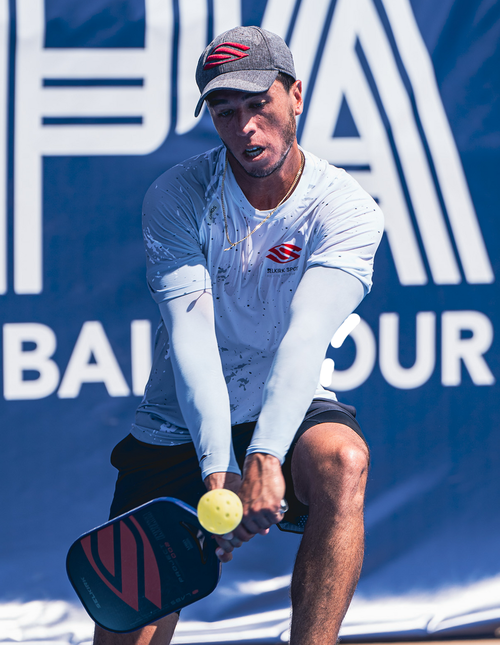 Pablo Tellez playing pickleball, preparing to hit a ball with a paddle.