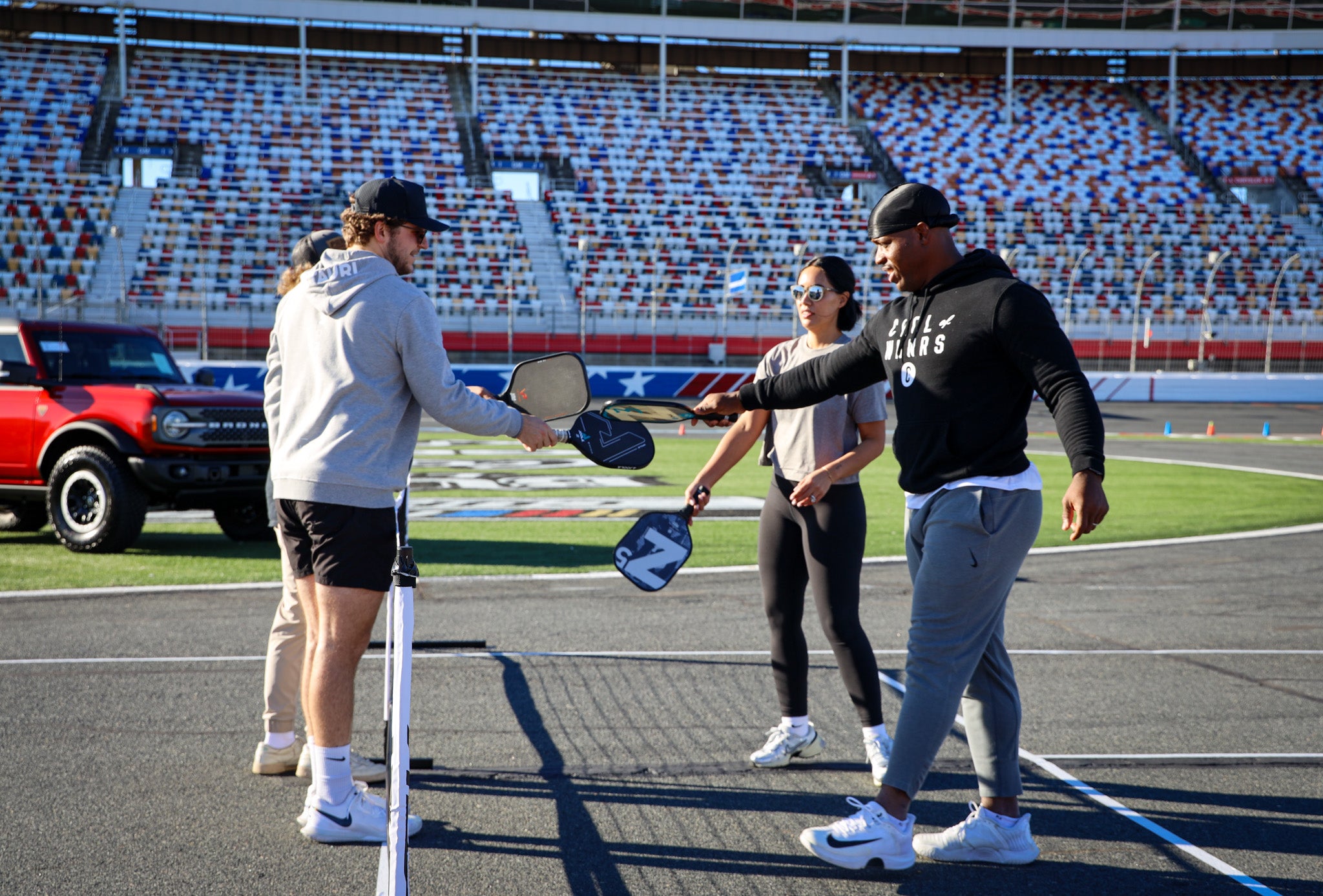 Austin Dillon and others playing pickleball on a NASCAR track