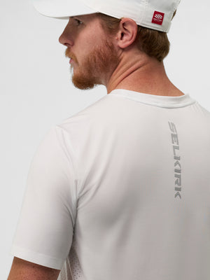 Man's back wearing a white shirt with vertical 'SELKIRK' logo on the upper back and a white cap