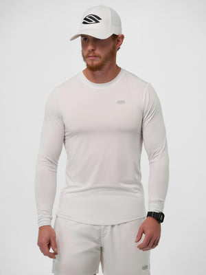 Male model wearing white long-sleeve performance shirt, white shorts, and a white cap with a black logo.