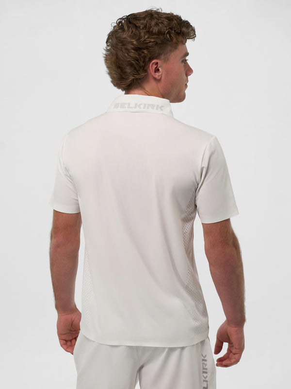 Model wearing the Men's Pro Line Performance Polo in Chalk, showing the back view.