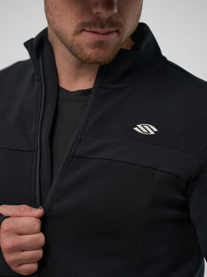 Man wearing a black Pro Line Full Zip Jacket, showcasing the logo and zipper detail.