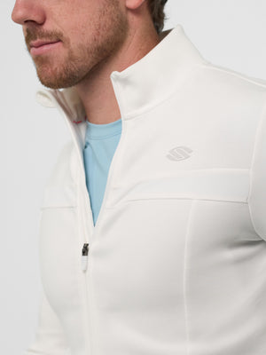 Male model wearing white zip-front jacket with small embossed chest logo, partly open to show light blue crew T-shirt.