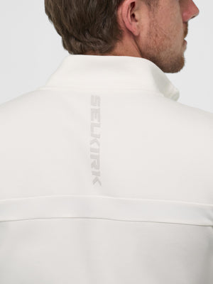 Back view of man wearing white sweatshirt with vertical SELKIRK logo centered on upper back
