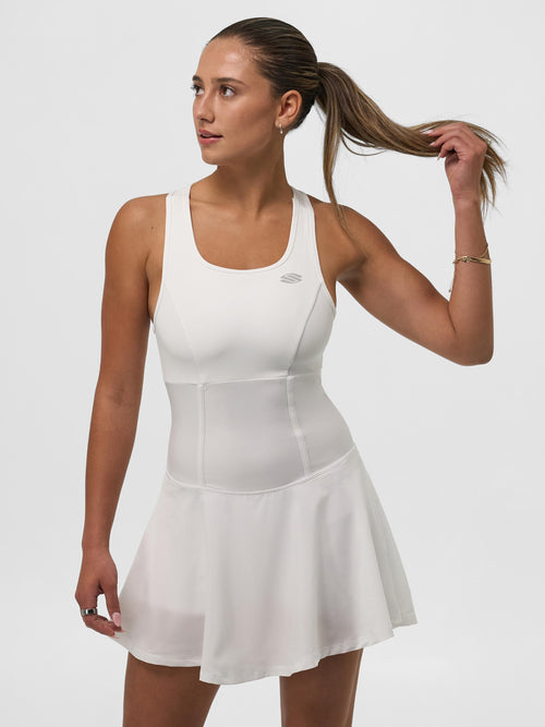 Woman wearing a white pickleball dress, showcasing athletic fit and lightweight fabric.