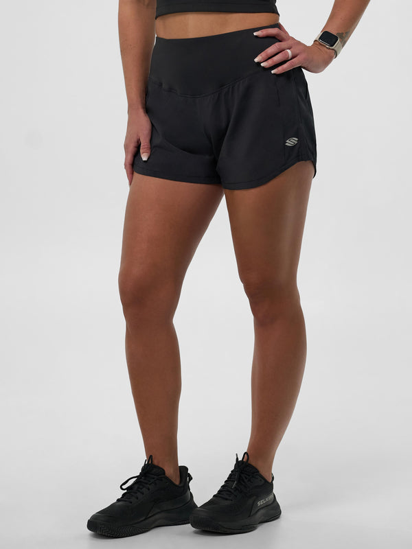 Model wearing Selkirk pickleball Blackout Women's Pro Line Woven Pickleball Shorts, showcasing the design and fit.