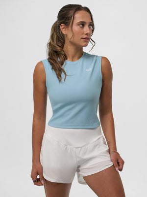 Model wearing a Selkirk pickleball blue Women's Pro Line Cap Sleeve Fitted Tee and white shorts
