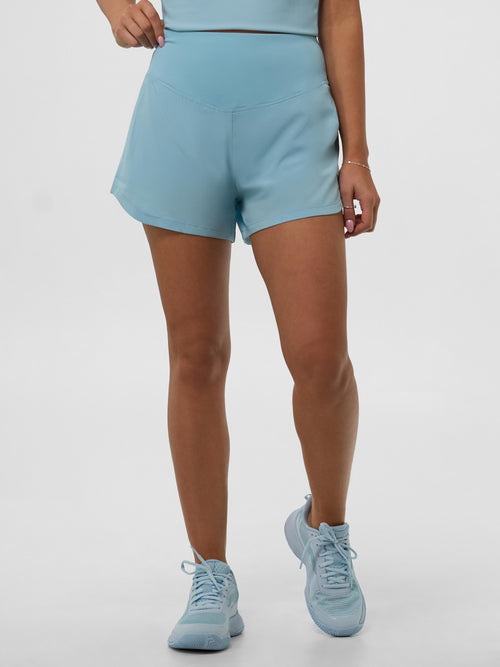 Light blue Women's Pro Line Woven Pickleball Shorts worn by a model