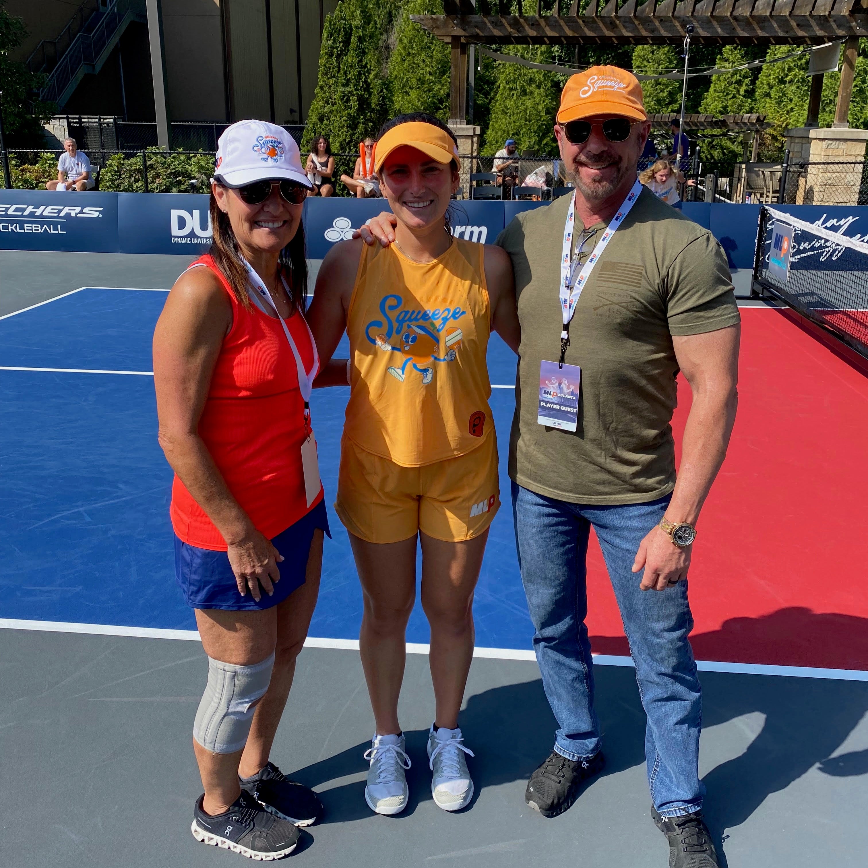 Pickleball pro Rachel Rohrabacher with her supportive parents at a pickleball event, smiling together.