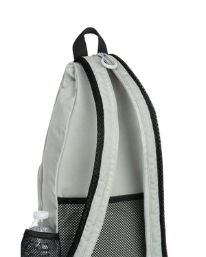 Side view of Selkirk Core Line sling bag in gray showing mesh side bottle pocket, padded strap, and top loop
