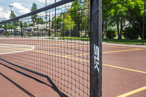 SLK Pro Portable Pickleball Net set up on a court with a clear view of the net and surroundings.