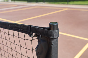 Close-up of the SLK Pro Portable Pickleball Net's top corner with a black strap and pole.