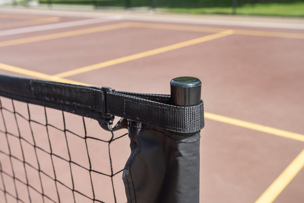 Close-up of the SLK Pro Portable Pickleball Net's top corner with a black strap and pole.