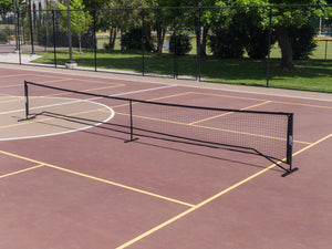 SLK Pro Portable Pickleball Net set up on a court with a powder-coated steel frame.