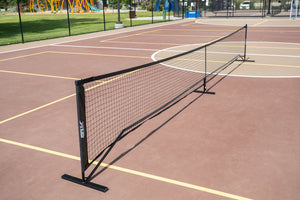 SLK Pro Portable Pickleball Net set up on a court with a black frame and netting.