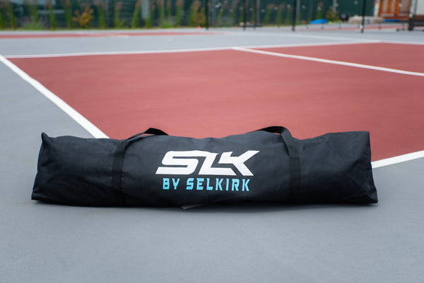 Carrying bag for SLK Prime Portable Pickleball Net on a court