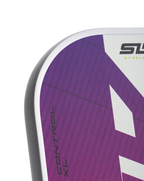 Close-up of the SLK EVO Control paddle showing the SpinFlex+ surface design and texture.