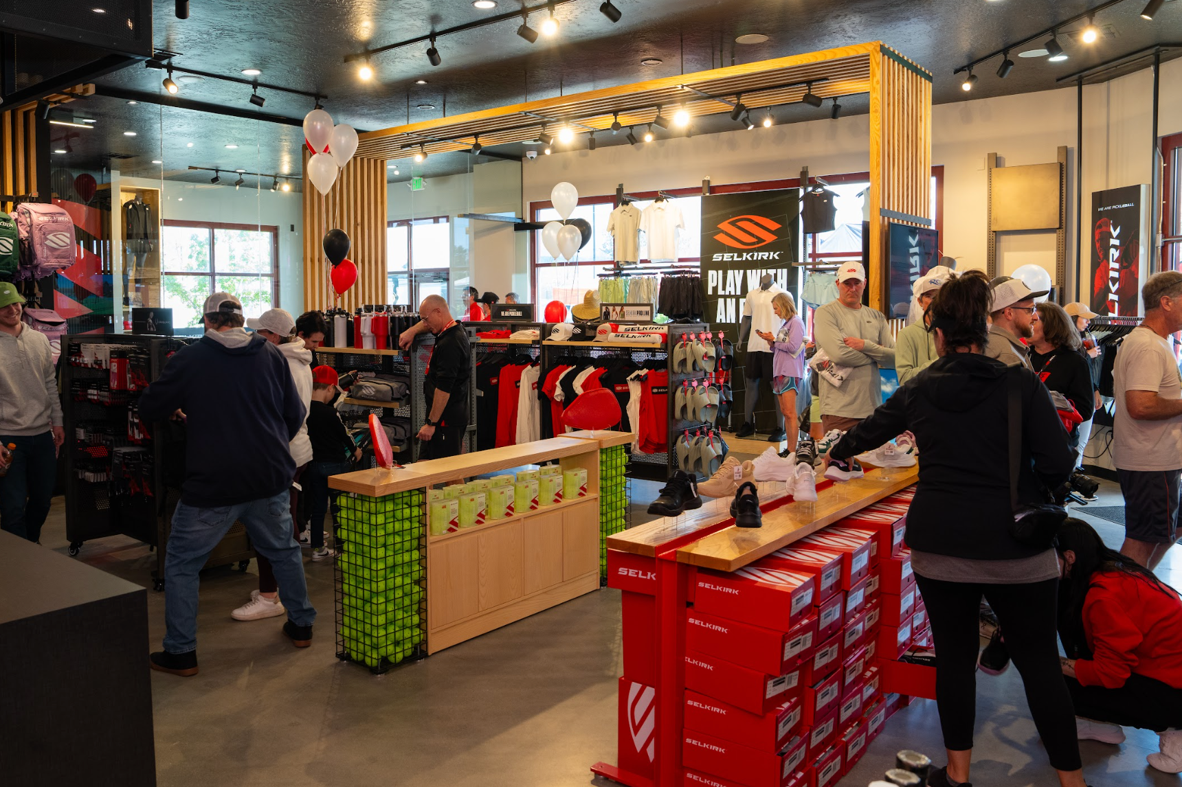 Customers try on shoes and shop for clothing in the Selkirk Pro Shop. 