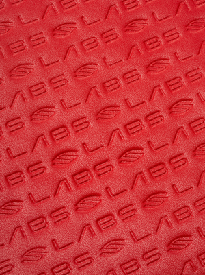 Textured red surface with 'LABS' embossed pattern