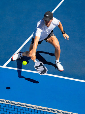 Player hitting a low forehand with the OMNI Chalk paddle