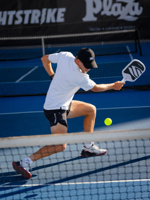 Player volleying at the net with the OMNI Chalk paddle