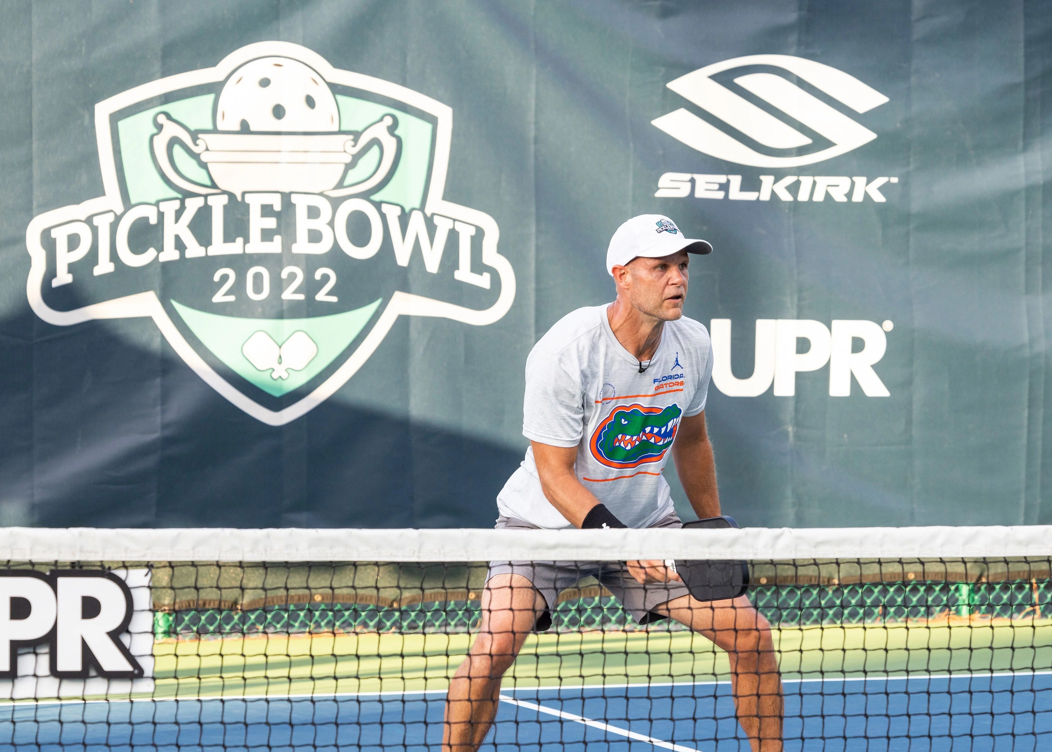 Photo of Selkirk Sport pickleball paddles and balls lying down on a pickleball court.