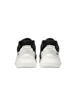 Rear view of a pair of black-and-white SELKIRK sneakers showing heel tabs with SELKIRK branding.