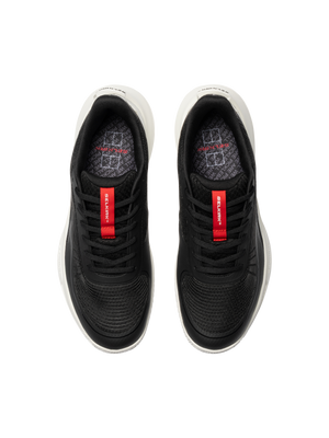 Top view of black athletic sneakers with red tongue labels reading 'Selkirk' and white midsoles.