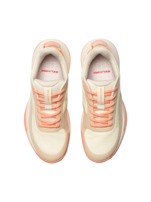 Top view, cream and peach athletic sneakers with SELKIRK printed on the insoles