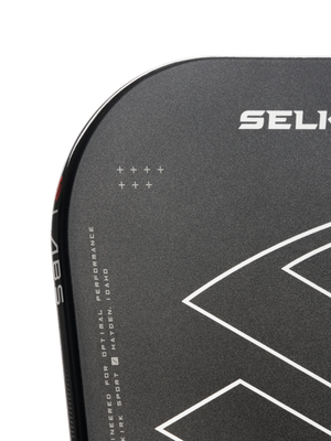 Corner of black paddle with SELK logo, white geometric design, vertical 'LABS', and text 'ENGINEERED FOR OPTIMAL PERFORMANCE HAYDEN, IDAHO'.